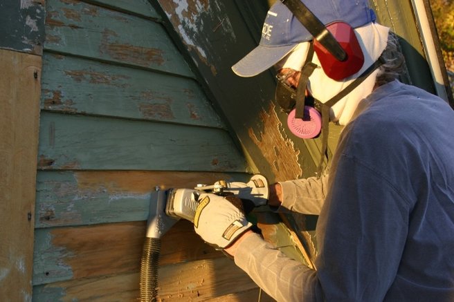 Nate stripping and refinishing the old siding, a job he does every few years